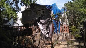 Storm and flood damage: a tree on a house roof